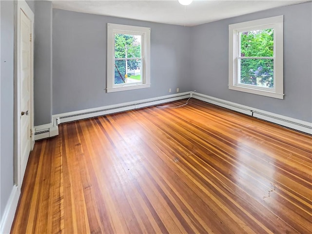 156 Broad St, Burrillville, RI 02859 - spare room featuring healthy amount of natural light, wood-type flooring, and a baseboard heating unit