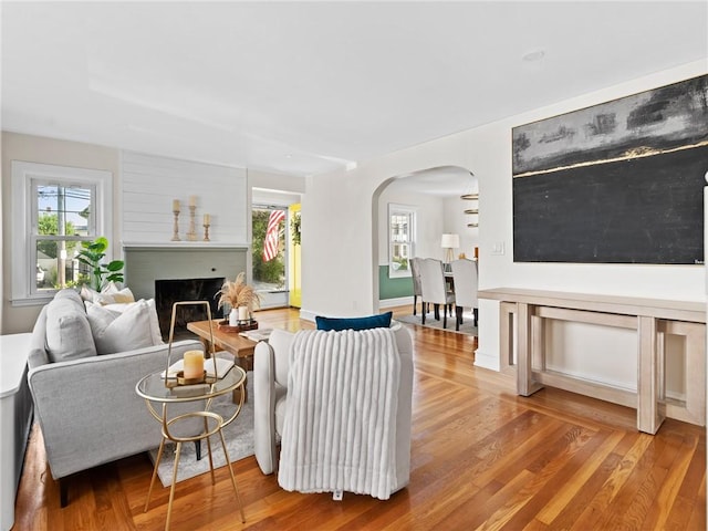 155 Hillside Ave, Providence, RI 02906 - living room featuring arched walkways, wood finished floors, and plenty of natural light