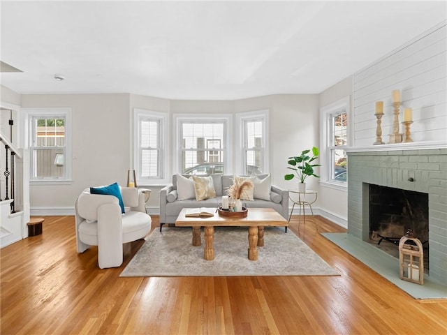 155 Hillside Ave, Providence, RI 02906 - living area featuring plenty of natural light, light wood finished floors, stairway, and a fireplace