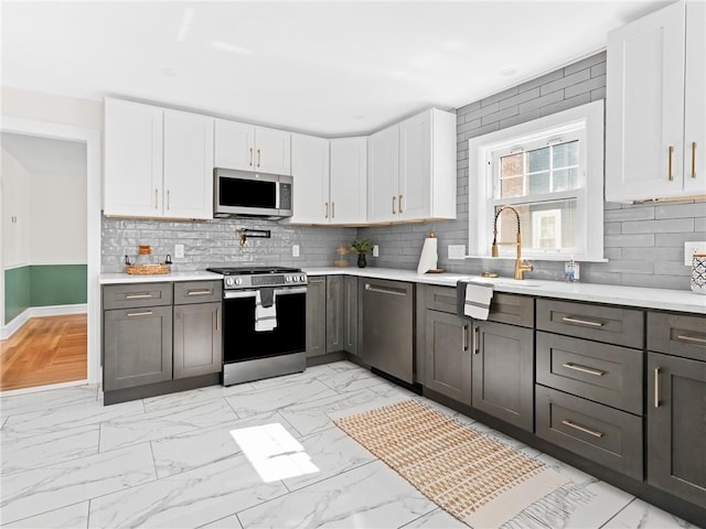 155 Hillside Ave, Providence, RI 02906 - kitchen with appliances with stainless steel finishes, light marble finish flooring, and light countertops