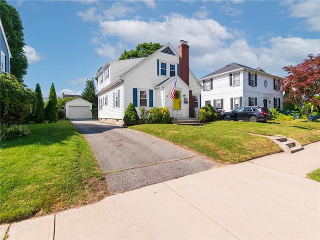 155 Hillside Ave, Providence, RI 02906 - view of front of home featuring an outbuilding, a detached garage, a front yard, and a chimney