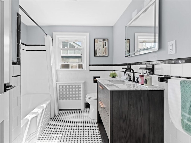 155 Hillside Ave, Providence, RI 02906 - bathroom with radiator, vanity, a wainscoted wall, shower / bath combo with shower curtain, and tile walls