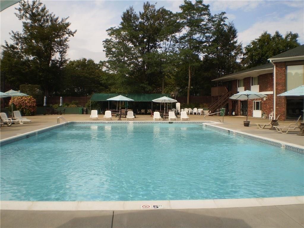 103 Edaville Ct Unit 103, Warwick, RI 02886 - community pool with a patio and stairway