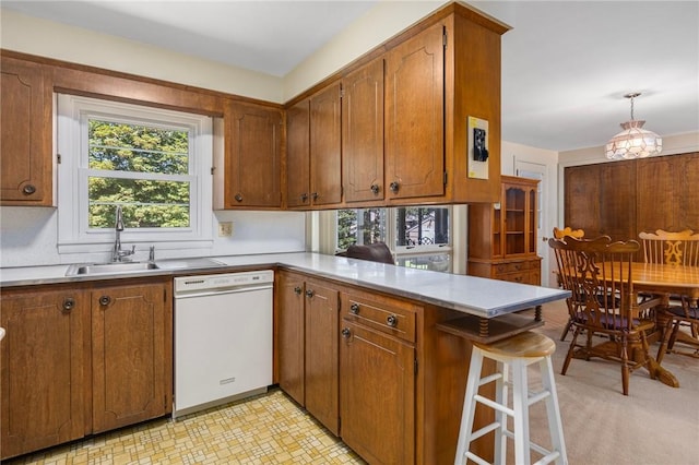 185 Sunnybrook Dr, North Kingstown, RI 02852 - kitchen with dishwasher, a peninsula, and brown cabinets