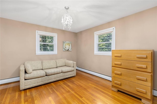 185 Sunnybrook Dr, North Kingstown, RI 02852 - living room featuring baseboard heating, plenty of natural light, and a chandelier