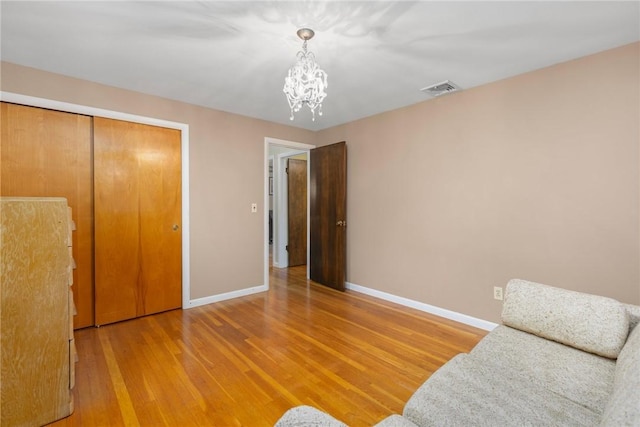 185 Sunnybrook Dr, North Kingstown, RI 02852 - living area with a chandelier and light wood-style floors