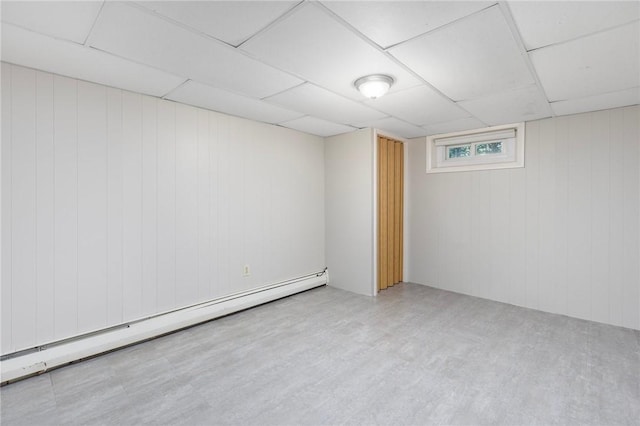 185 Sunnybrook Dr, North Kingstown, RI 02852 - basement featuring a baseboard heating unit, a drop ceiling, and wooden walls