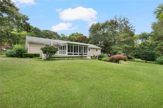 185 Sunnybrook Dr, North Kingstown, RI 02852 - rear view of property featuring a sunroom, a chimney, a lawn, and view of scattered trees