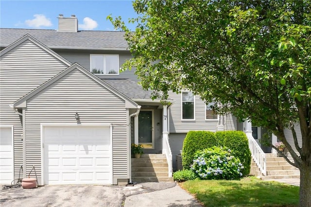 76 Valley Green Ct Unit B, North Providence, RI 02904 - view of front facade with a shingled roof, a garage, stairs, a chimney, and driveway
