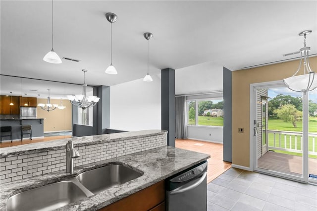76 Valley Green Ct Unit B, North Providence, RI 02904 - kitchen featuring stainless steel appliances, a chandelier, dark stone counters, pendant lighting, and light tile patterned floors
