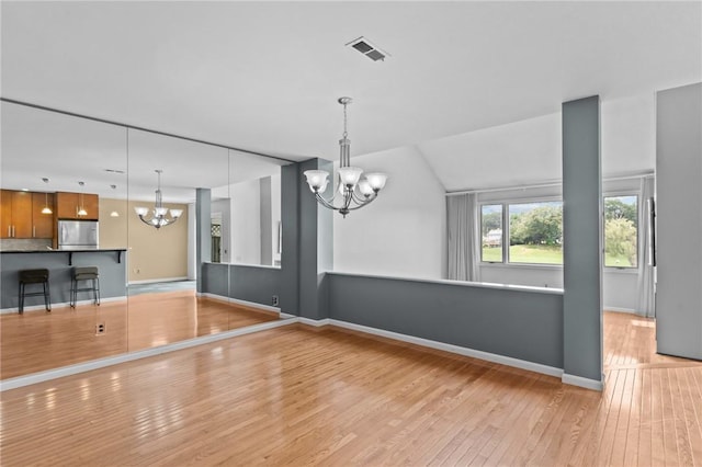 76 Valley Green Ct Unit B, North Providence, RI 02904 - unfurnished living room with a chandelier and light wood-style floors