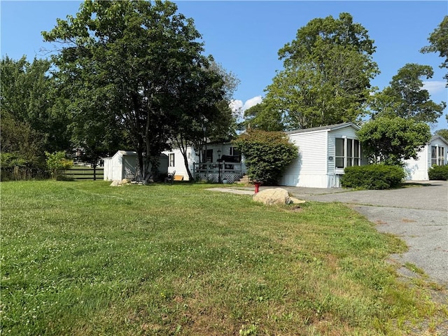225 Brayton Ave, Tiverton, RI 02878 - view of grassy yard with driveway and a storage shed
