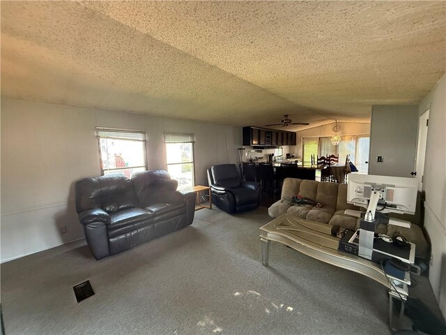 225 Brayton Ave, Tiverton, RI 02878 - carpeted living room with lofted ceiling, a ceiling fan, and a textured ceiling