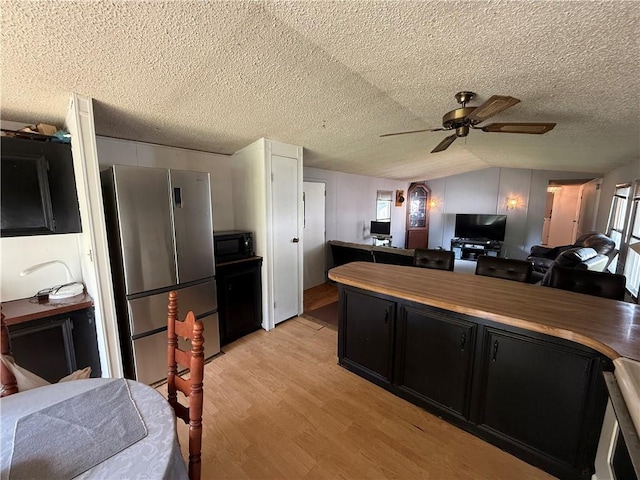225 Brayton Ave, Tiverton, RI 02878 - kitchen with freestanding refrigerator, black microwave, open floor plan, dark cabinetry, and wooden counters