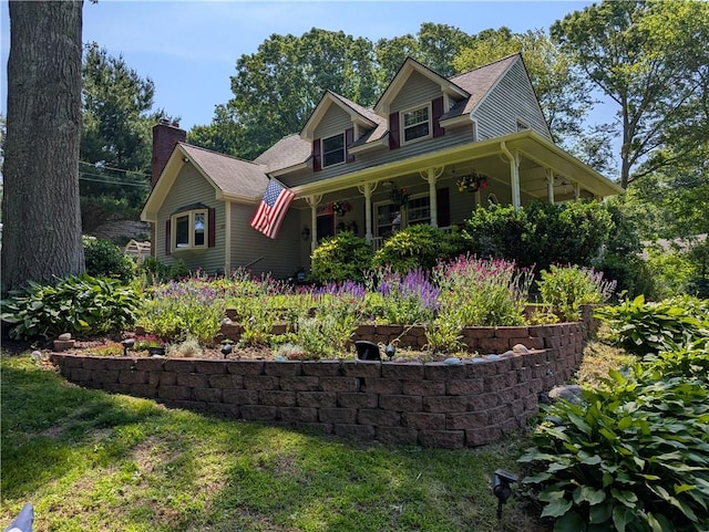 50 Betony Rd, Narragansett, RI 02874 - view of front facade with a chimney, covered porch, and a front yard
