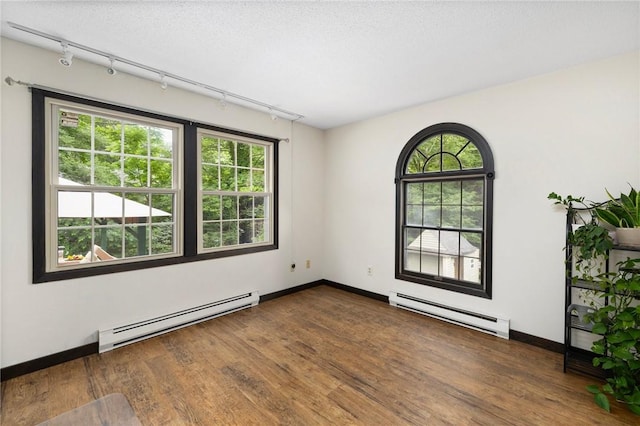 50 Betony Rd, Narragansett, RI 02874 - unfurnished room featuring baseboard heating, rail lighting, and wood finished floors