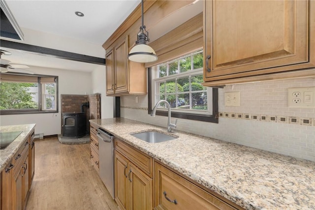 50 Betony Rd, Narragansett, RI 02874 - kitchen with a wood stove, stainless steel dishwasher, light wood-style floors, tasteful backsplash, and light stone countertops