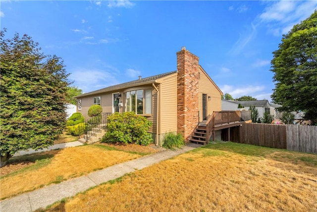59 Columbus Ave, North Providence, RI 02911 - view of side of home featuring a chimney, stairway, and a wooden deck