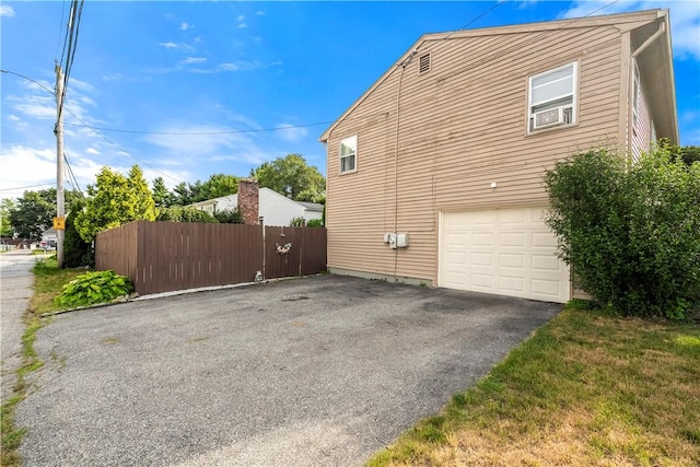 59 Columbus Ave, North Providence, RI 02911 - view of side of home with a garage and driveway