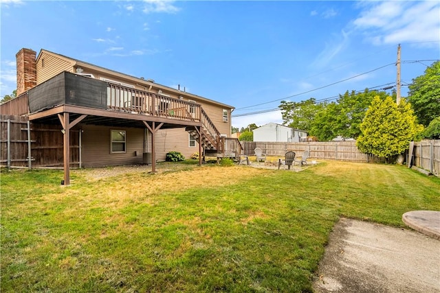 59 Columbus Ave, North Providence, RI 02911 - rear view of property featuring a deck, a fenced backyard, stairs, and a fire pit