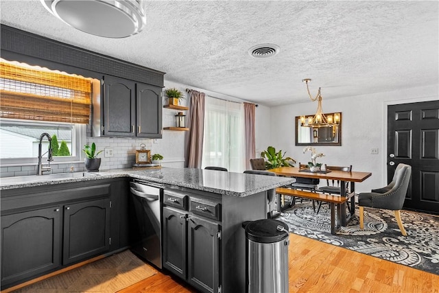 59 Columbus Ave, North Providence, RI 02911 - kitchen featuring dishwasher, a peninsula, plenty of natural light, a chandelier, and a textured ceiling