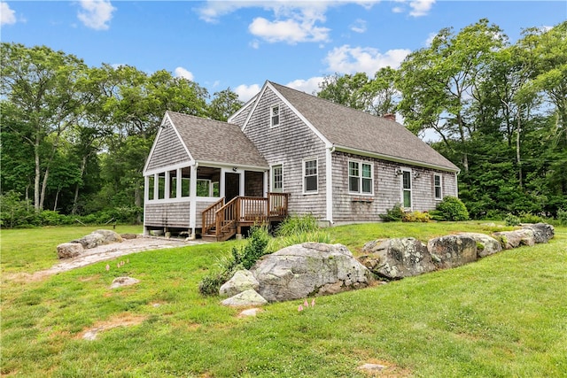140 Long Hwy, Little Compton, RI 02837 - view of front of property featuring a sunroom, a chimney, a shingled roof, and a front lawn