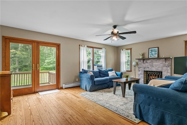 140 Long Hwy, Little Compton, RI 02837 - living area featuring a baseboard radiator, wood finished floors, a ceiling fan, a fireplace, and french doors