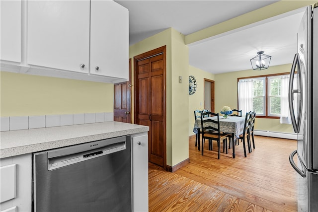 140 Long Hwy, Little Compton, RI 02837 - kitchen with stainless steel appliances, light wood-style floors, light countertops, and a baseboard radiator