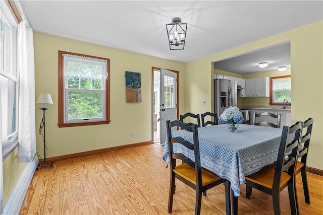 140 Long Hwy, Little Compton, RI 02837 - dining space featuring a chandelier, light wood finished floors, and healthy amount of natural light