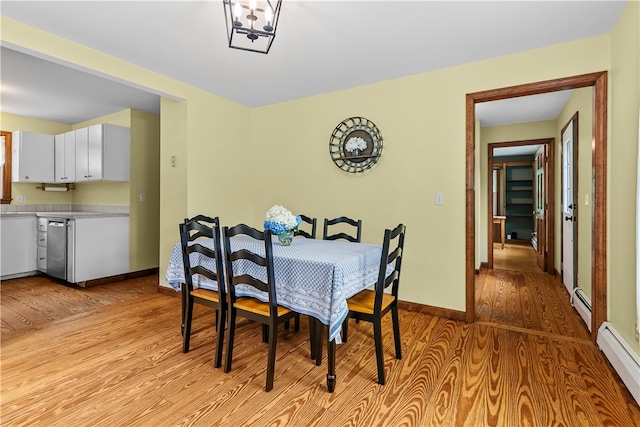 140 Long Hwy, Little Compton, RI 02837 - dining area with baseboard heating, light wood finished floors, and a baseboard radiator