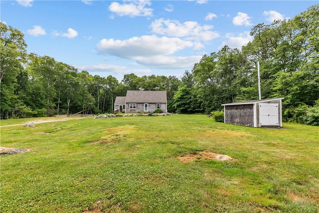 140 Long Hwy, Little Compton, RI 02837 - view of green lawn with a storage shed and a view of trees