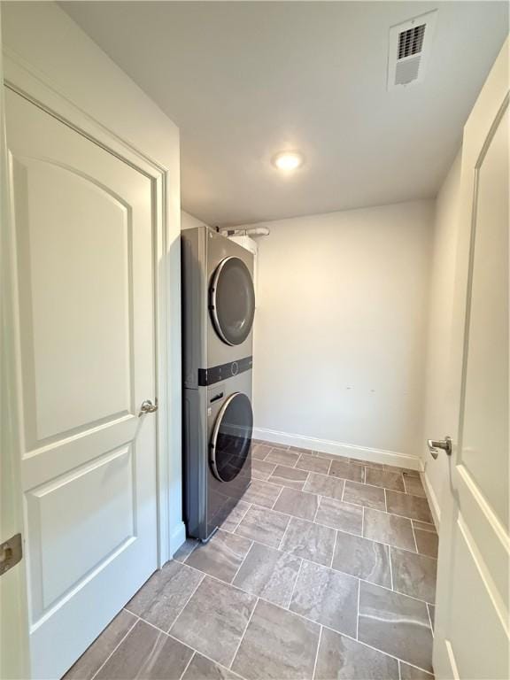 77 Batcheller Ave, Cranston, RI 02920 - laundry room with stacked washer / dryer and stone finish floors