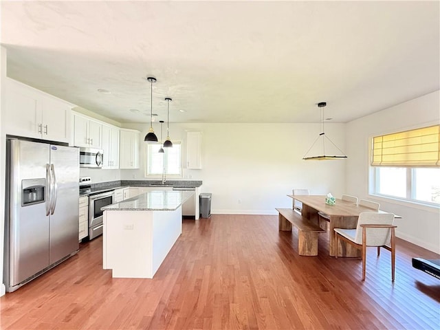 77 Batcheller Ave, Cranston, RI 02920 - kitchen with appliances with stainless steel finishes, plenty of natural light, a center island, and light wood-style floors