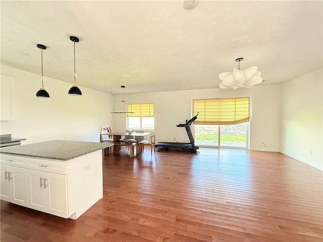 77 Batcheller Ave, Cranston, RI 02920 - kitchen featuring wood finished floors, white cabinetry, pendant lighting, a center island, and dark stone countertops