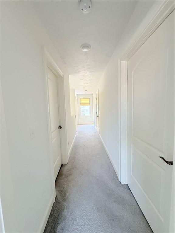 77 Batcheller Ave, Cranston, RI 02920 - corridor featuring light carpet and baseboards