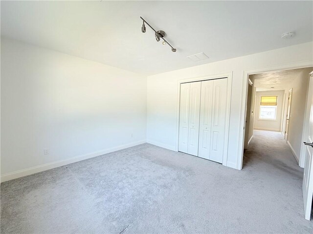 77 Batcheller Ave, Cranston, RI 02920 - unfurnished bedroom with light colored carpet, a closet, and rail lighting