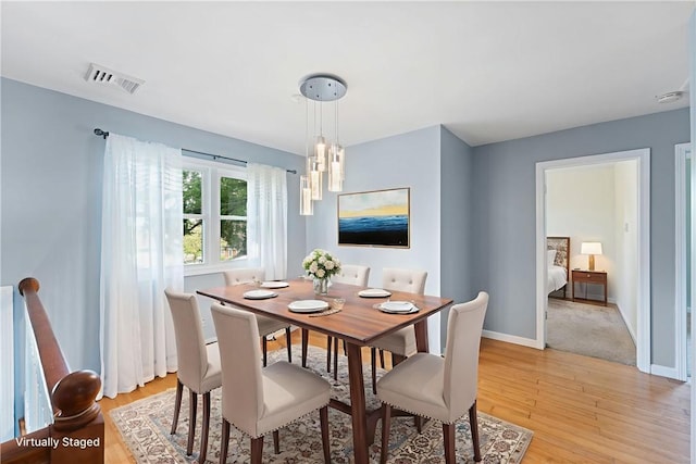 22 Riverdale Rd, Westerly, RI 02891 - dining area with light wood-style floors and a chandelier