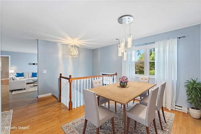 22 Riverdale Rd, Westerly, RI 02891 - dining area with light wood-type flooring, a baseboard radiator, and a chandelier