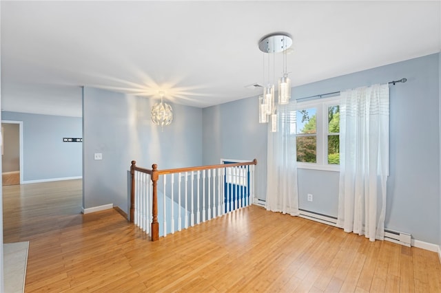 22 Riverdale Rd, Westerly, RI 02891 - unfurnished room with baseboard heating, a chandelier, and wood finished floors