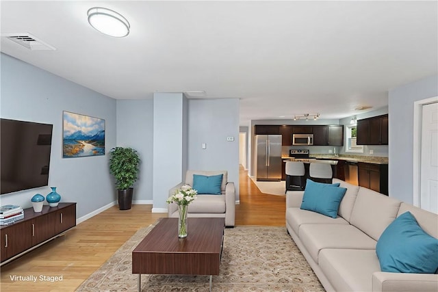 22 Riverdale Rd, Westerly, RI 02891 - living room featuring light wood finished floors and rail lighting