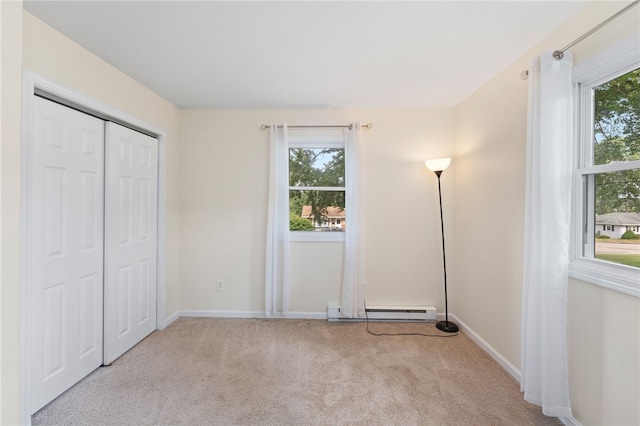 22 Riverdale Rd, Westerly, RI 02891 - unfurnished bedroom featuring multiple windows, carpet, a baseboard heating unit, and a closet