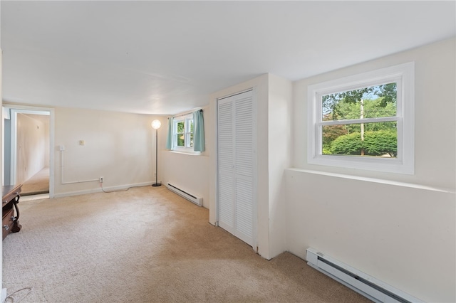 22 Riverdale Rd, Westerly, RI 02891 - unfurnished bedroom featuring a baseboard heating unit, light colored carpet, and a closet