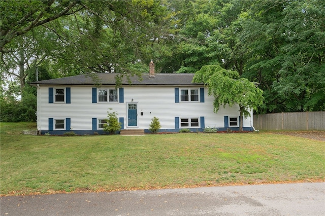 22 Riverdale Rd, Westerly, RI 02891 - raised ranch with a chimney and view of wooded area