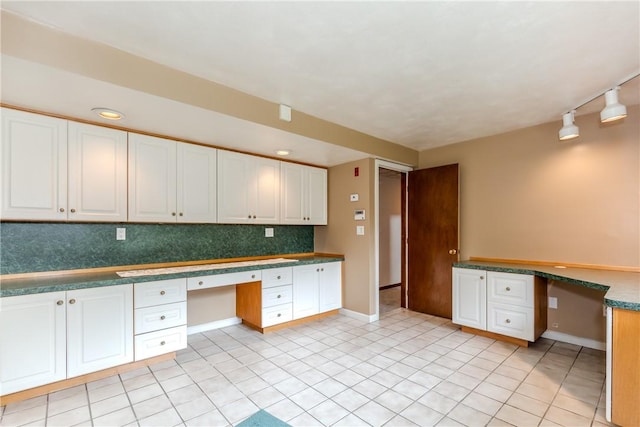 422 Buxton St, North Smithfield, RI 02896 - kitchen featuring built in study area, white cabinetry, backsplash, rail lighting, and recessed lighting