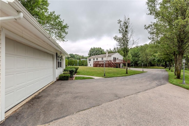 422 Buxton St, North Smithfield, RI 02896 - exterior space featuring a garage, driveway, and a wooden deck