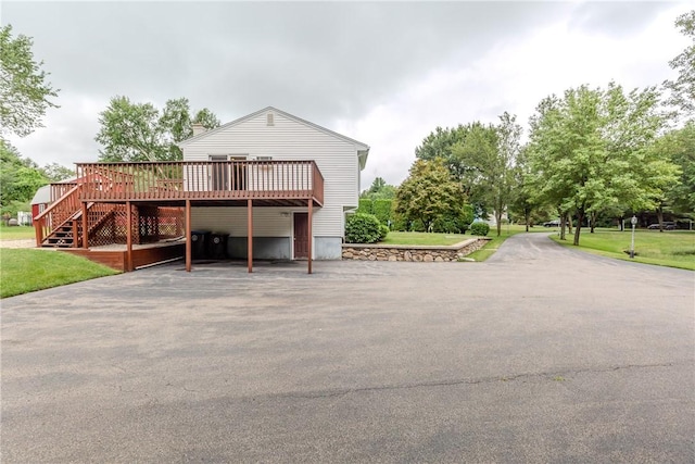 422 Buxton St, North Smithfield, RI 02896 - view of front of property with a deck, driveway, stairs, and a front lawn