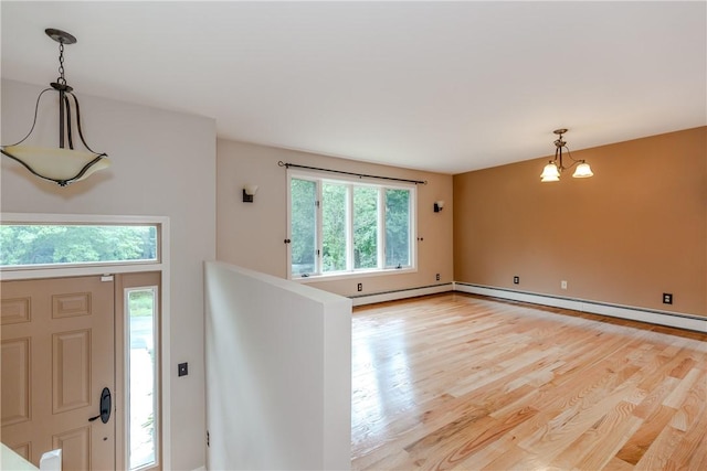422 Buxton St, North Smithfield, RI 02896 - entryway featuring plenty of natural light, light wood finished floors, and a chandelier