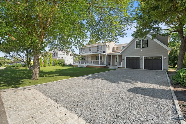 26 Westmoreland St, Narragansett, RI 02882 - view of front of property with covered porch, gravel driveway, a garage, and a front lawn