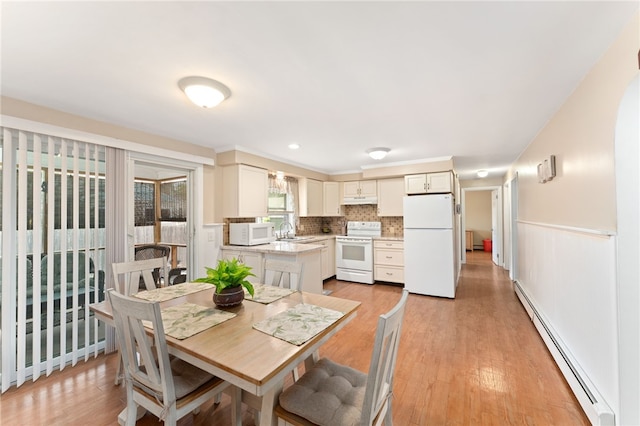 67 Vera St, Warwick, RI 02886 - dining space featuring baseboard heating, light wood-style floors, and wainscoting