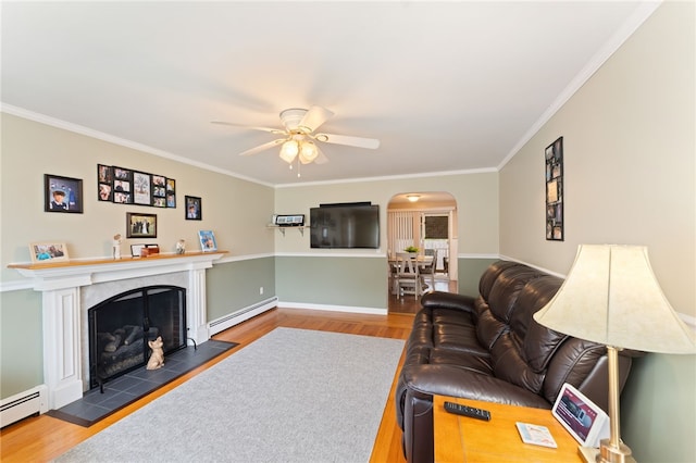 67 Vera St, Warwick, RI 02886 - living area with baseboard heating, wood finished floors, ceiling fan, ornamental molding, and a fireplace